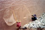 Two women fishing at the banks of the Mekong river